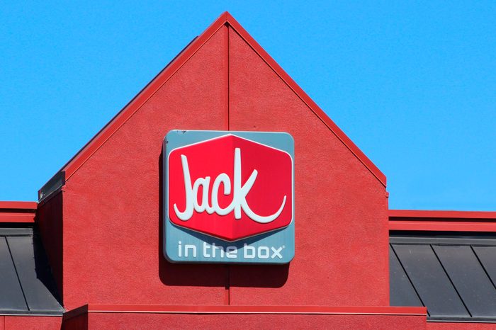 Vista, CA / USA - June 11, 2018: Close up of a red Jack in the Box building with signage against bright blue sky
