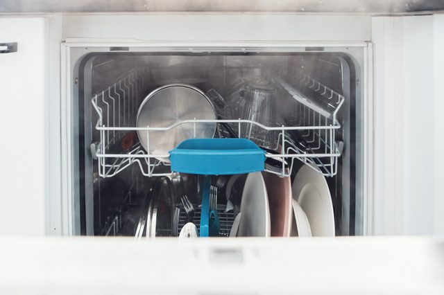 dishwasher for washing dishes, dishwashing machine open for dishware with lots of dishes for dish washing basket cutlery