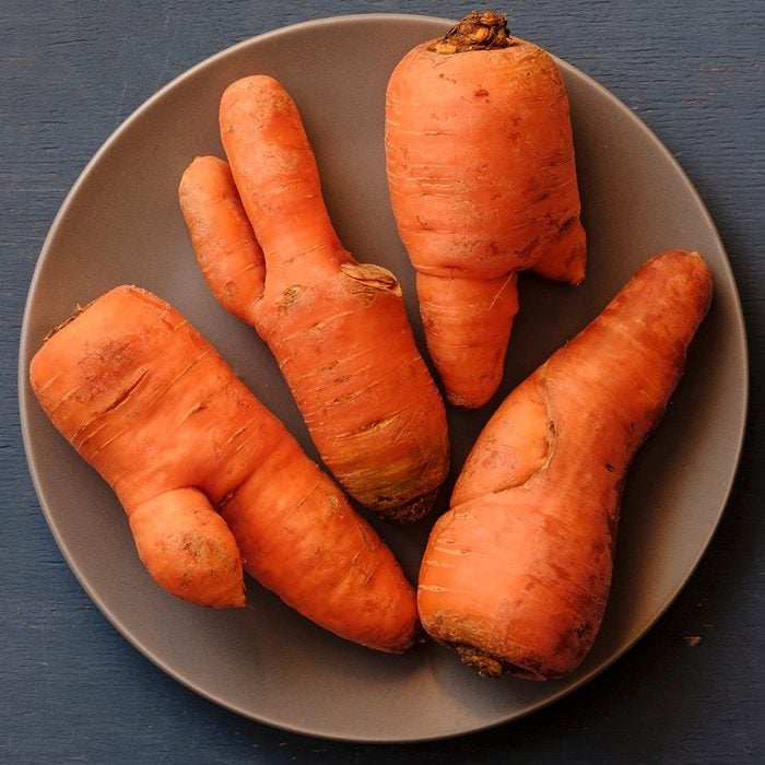 Plate with ugly carrots of different unusual imperfect shapes, viewed from above on grey background; Shutterstock ID 1322445116; Job (TFH, TOH, RD, BNB, CWM, CM): TOH