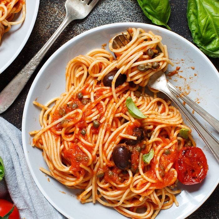 Pasta alla puttanesca - Spaghetti with tomato sauce olives and capers; Shutterstock ID 1372335800; Job (TFH, TOH, RD, BNB, CWM, CM): TOH
