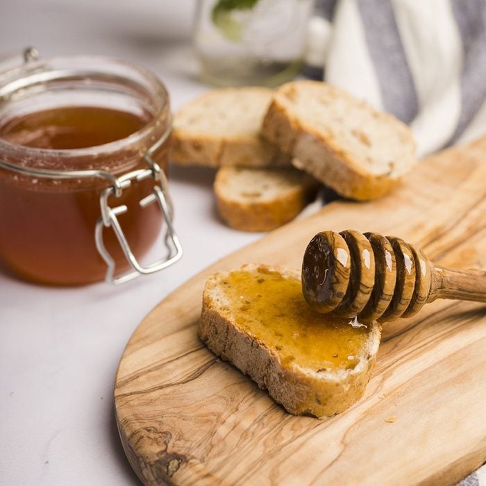 Glass jar full of honey with honey spoon; Shutterstock ID 1426272716; Job (TFH, TOH, RD, BNB, CWM, CM): TOH