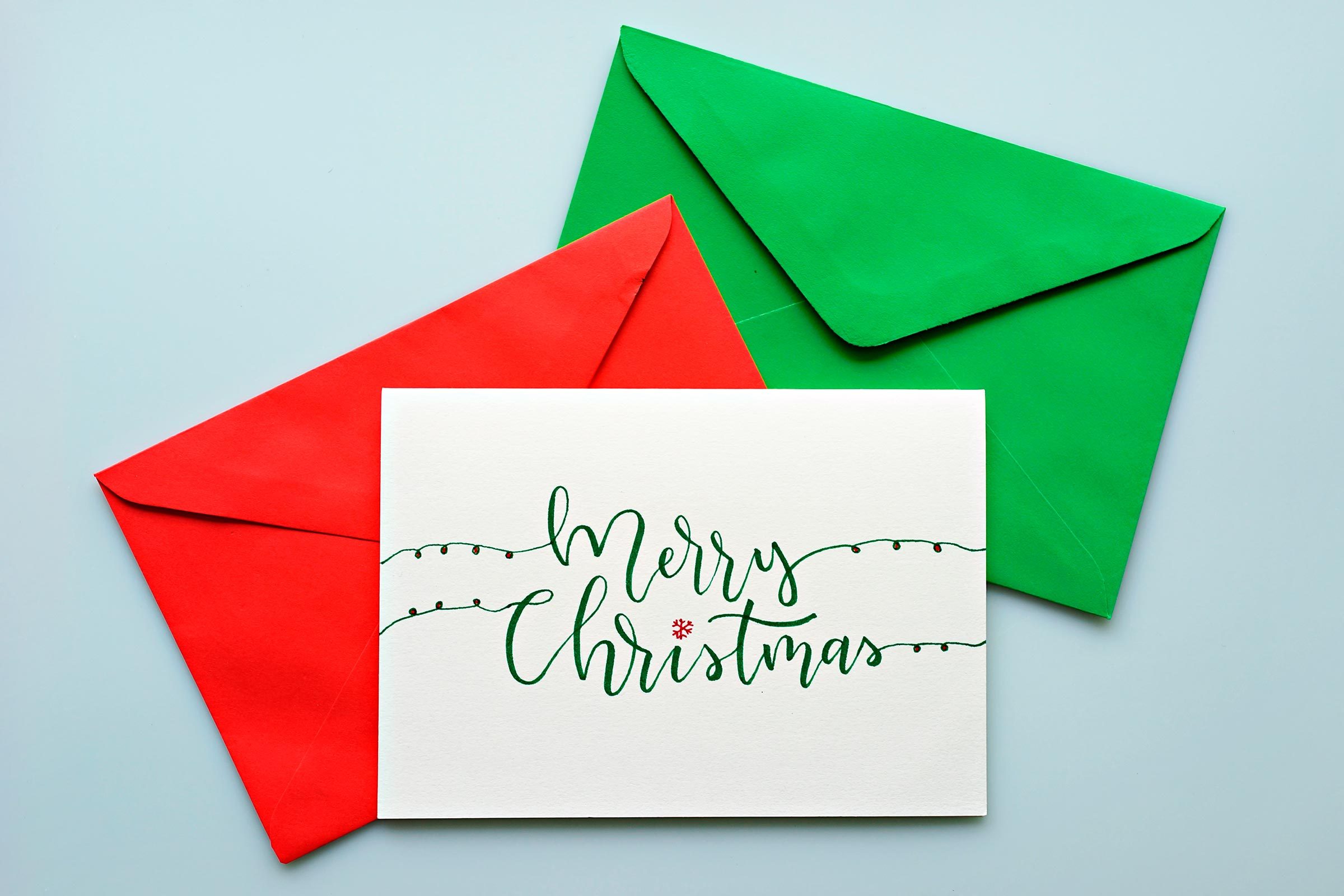 Top view hand drawn Christmas greeting cards with envelope.