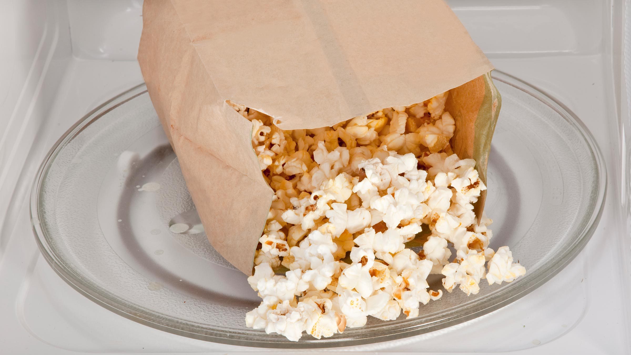 Popcorn cooked in a microwave oven still in the bag.
