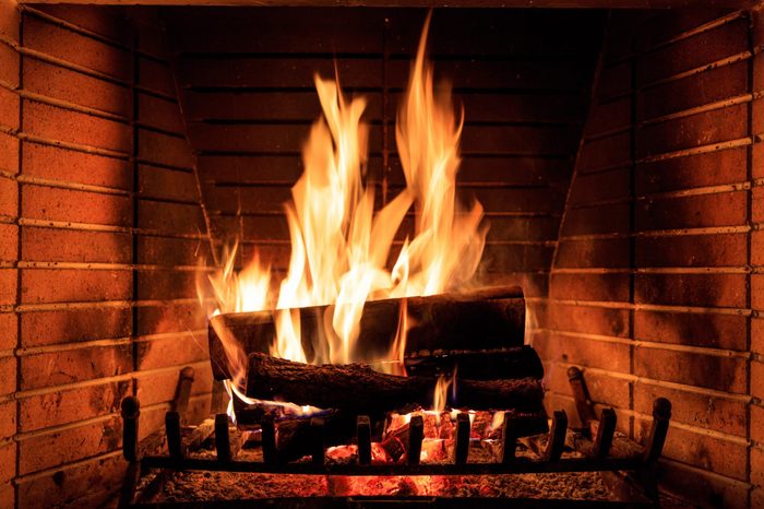 Wood burning in a cozy fireplace at home