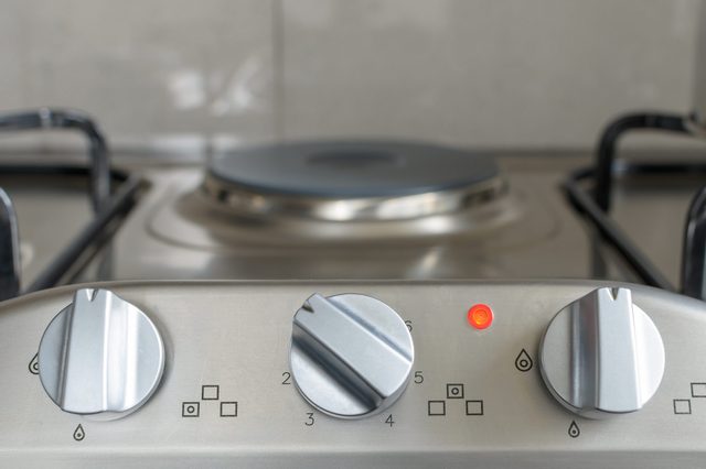 electrical stove knob in kitchen work top with operation light on