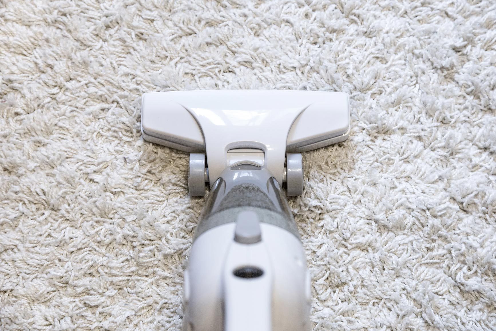 White vacuum on white carpet