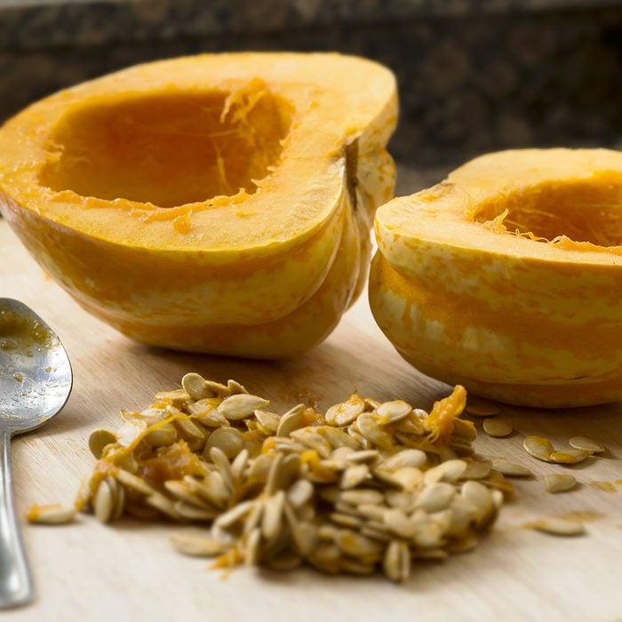 holiday cooking tips - Winter squash cut in half with spoon and seeds scooped out.; Shutterstock ID 175357406; Job (TFH, TOH, RD, BNB, CWM, CM): TOH