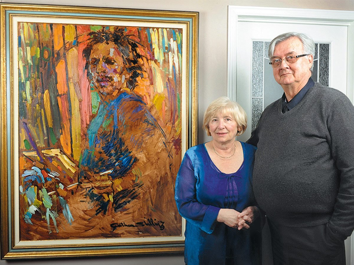 Rudy and Gloria Bies in front of a painting by Arthur Shilling