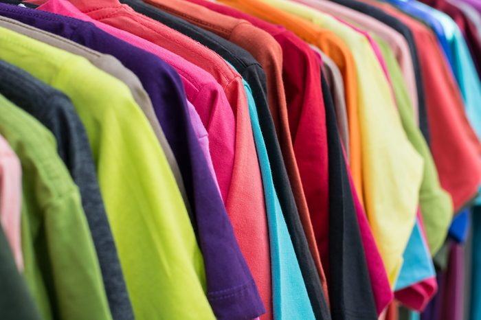 row of color T-SHIRT hanging on clothes hanger, concept of rainbow in nature