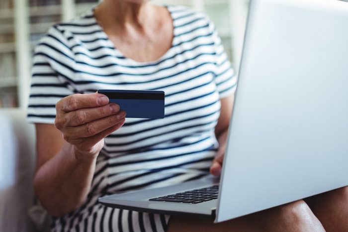 Senior woman doing online shopping on laptop at home