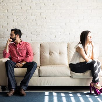 Things To Never Do After Fight - Couple sitting on couch away from each other