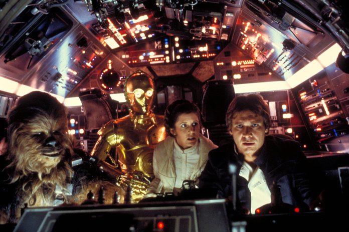 Peter Mayhew, Anthony Daniels, Carrie Fisher, Harrison Ford in the cockpit of the Millenium Falcon