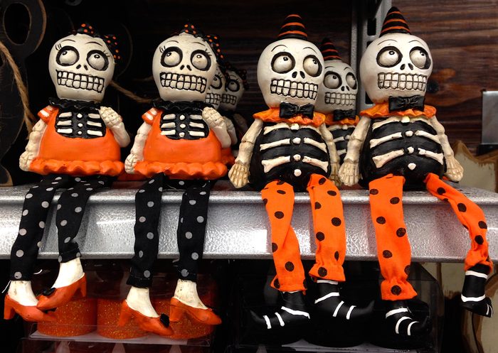 Small skeleton dolls in clothes on a shelf