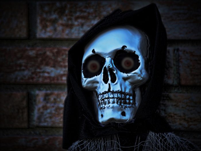 Face of a grim reaper wearing a hood