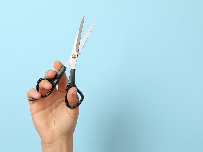 Hands holding scissors