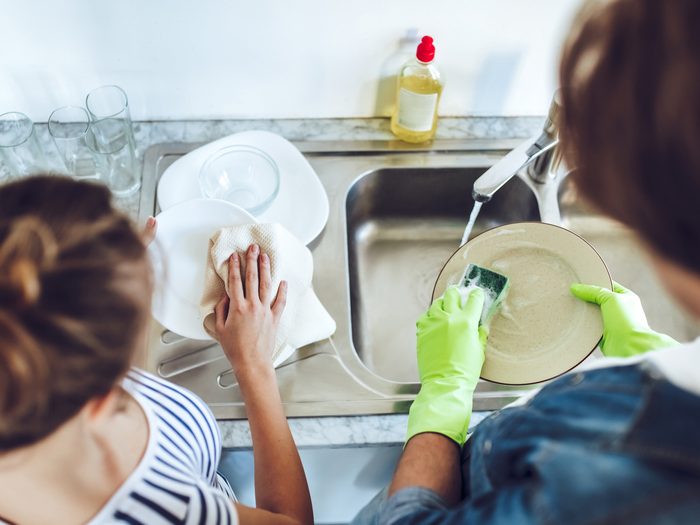 Two people washing dishes