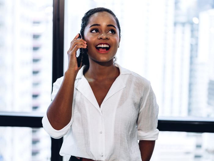Woman standing in an office talking on the phone