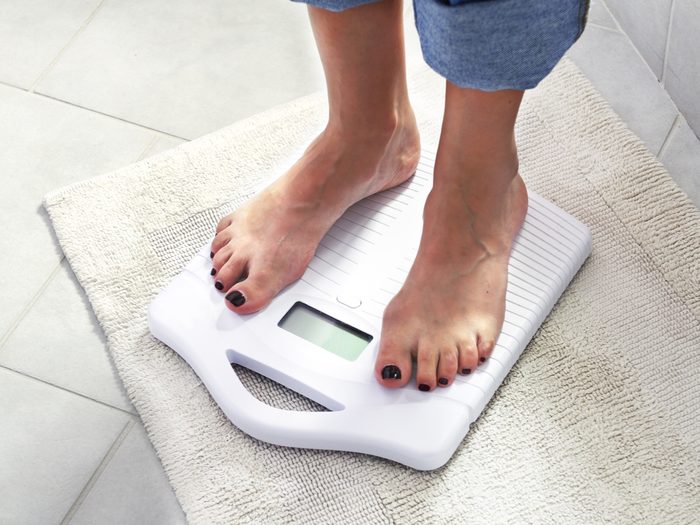 How to live to 100 - person weighing on scale