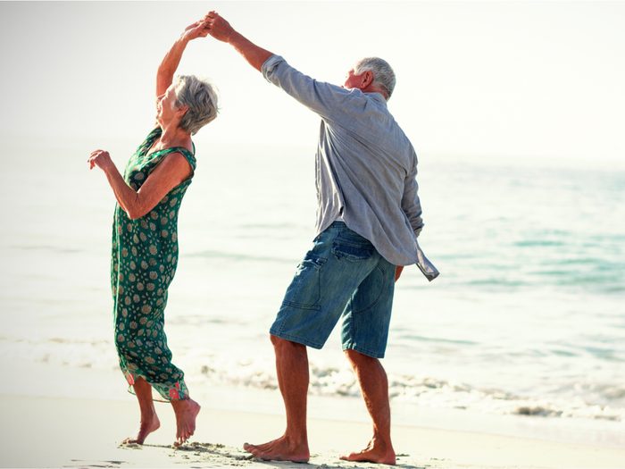 How to live to 100 - Senior couple dancing on the beach