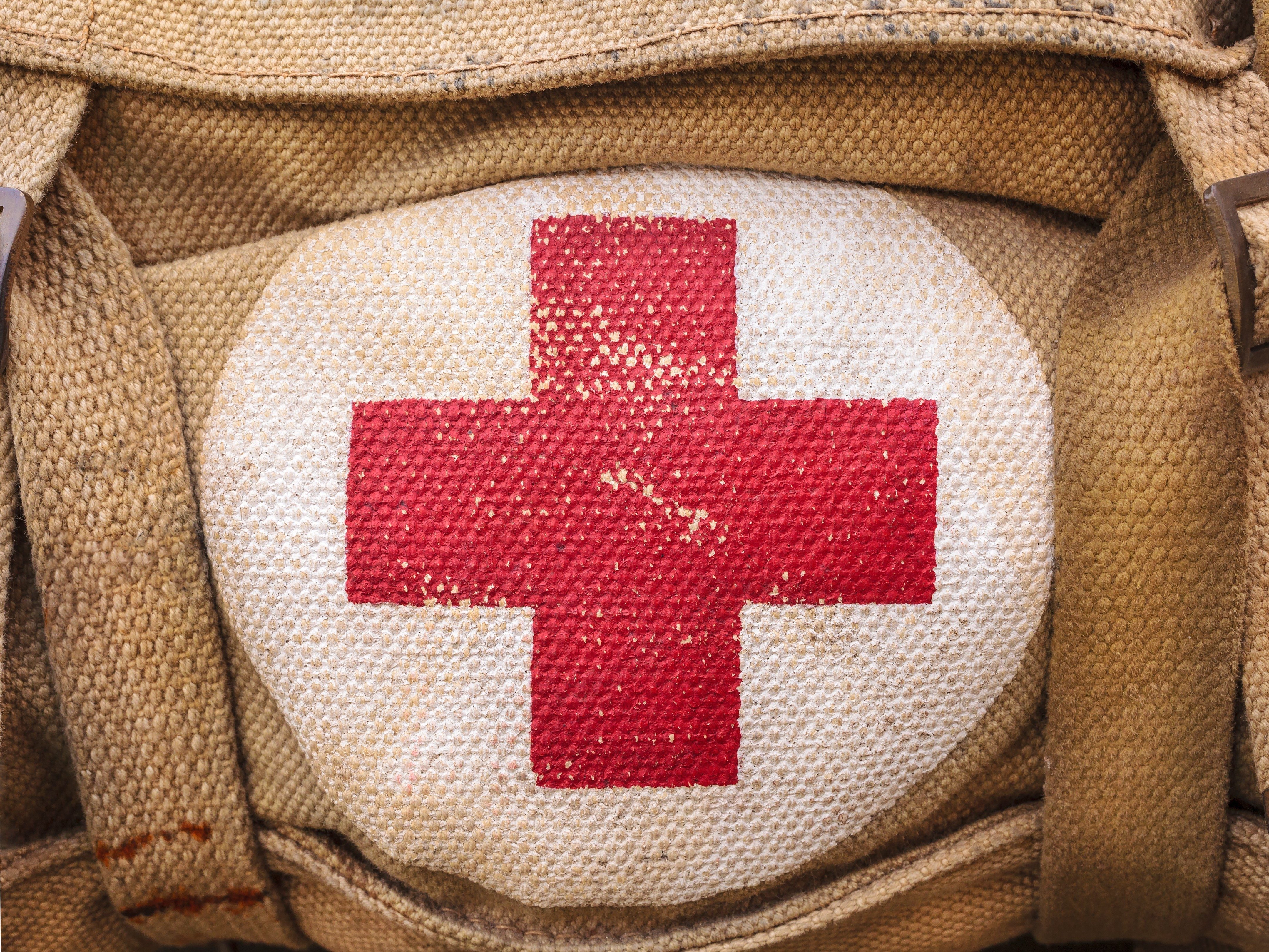 medical aid symbol on a vintage jute army bag