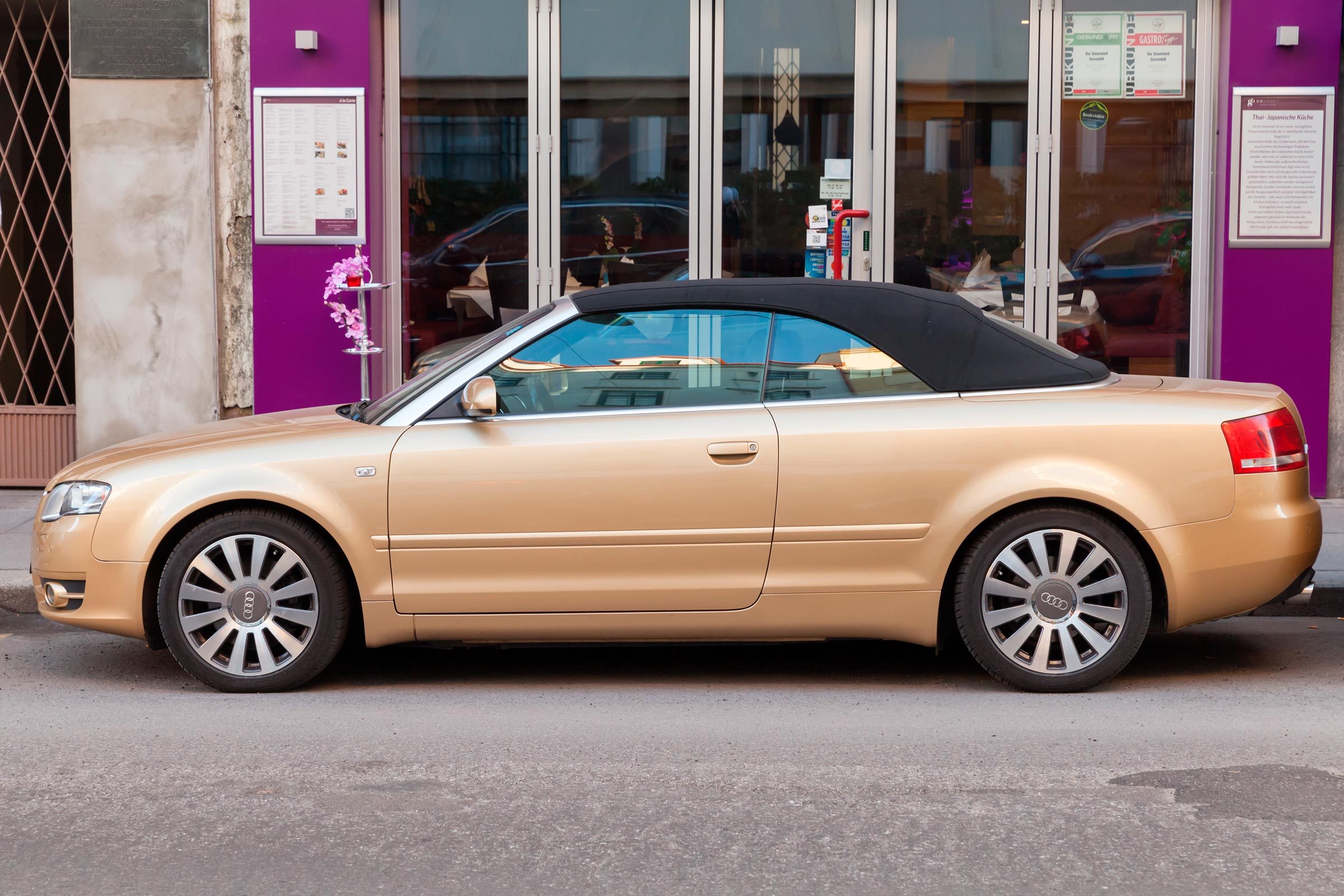 metallic gold Audi A4 Cabriolet stands on the city street
