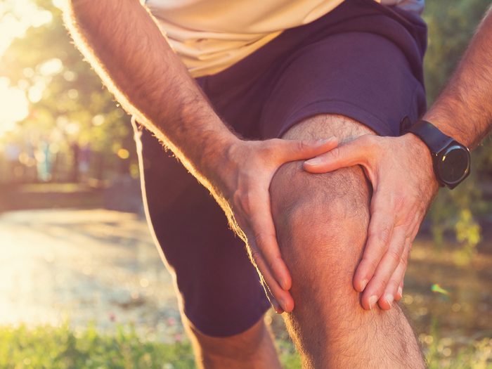 Signs you need more exercise - man holding painful knee