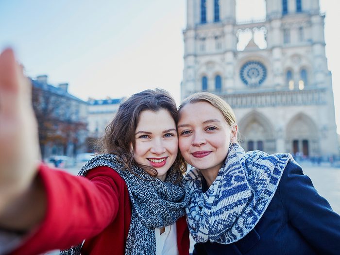 Two women in front of Notre Dame Cathedral in Paris