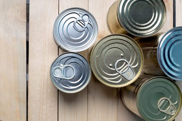 Tin cans for food on wooden background