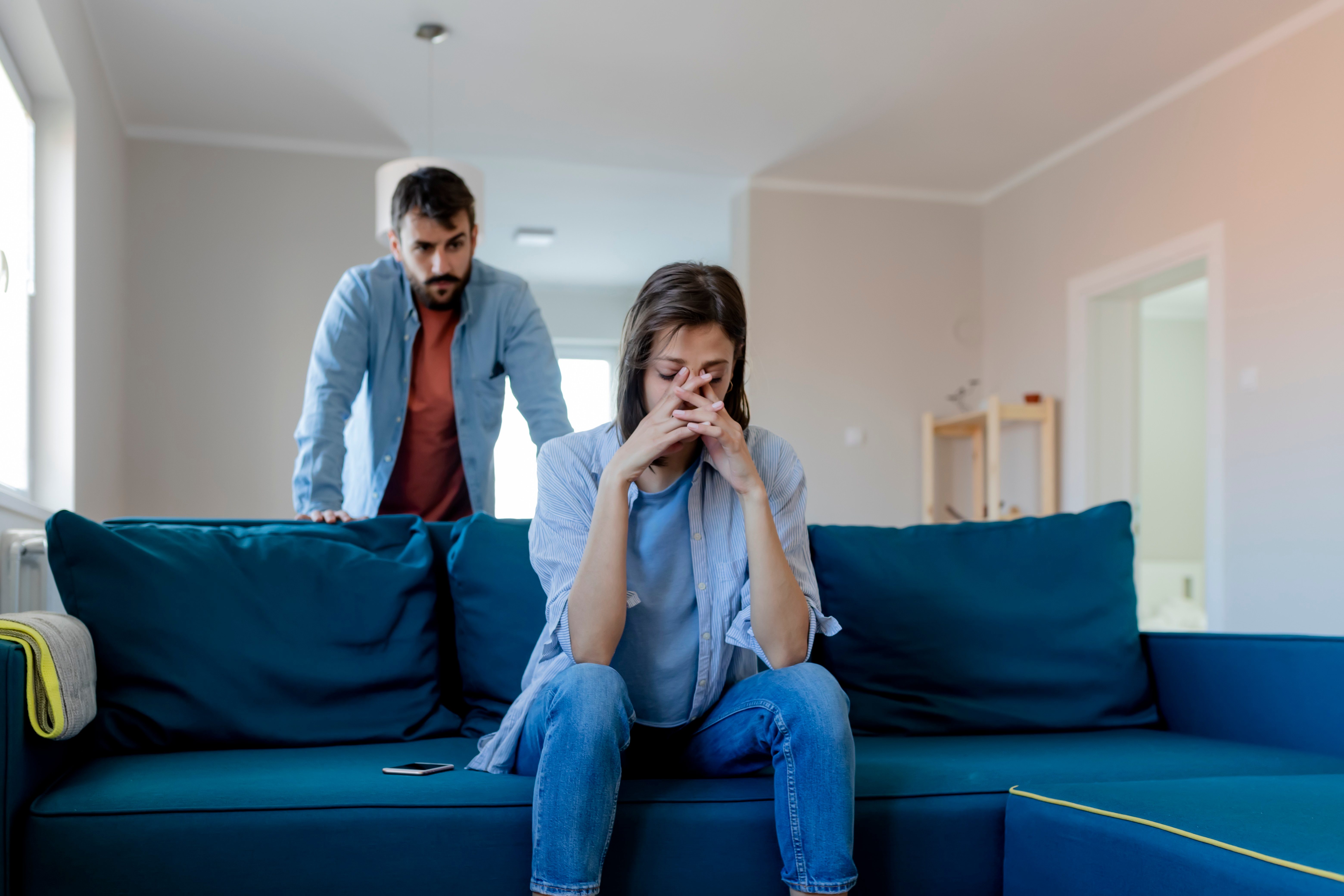 upset couple in their living room