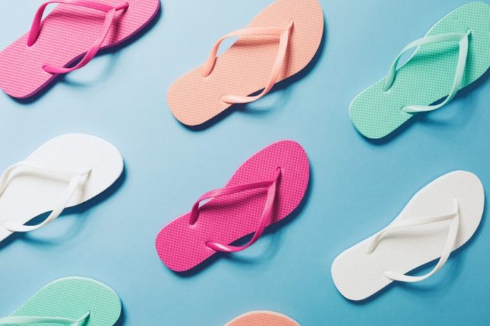Overhead view of flip flops on the blue background.