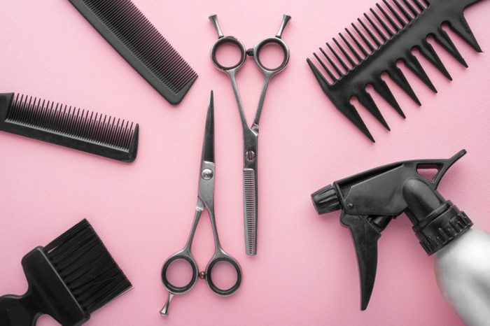 Professional hairdresser tools top view. on pink background.
