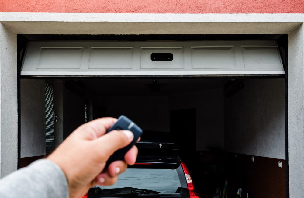 Garage door PVC. Hand use remote controller for closing and opening garage door.