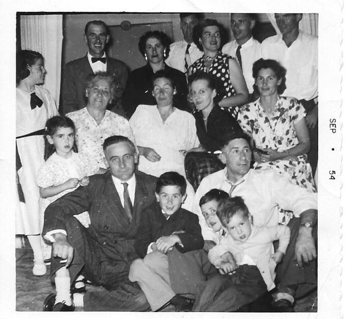 Black and white photo of an extended family gathered at Christmas