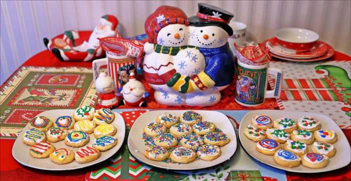 Three plates of Christmas-themed cookies