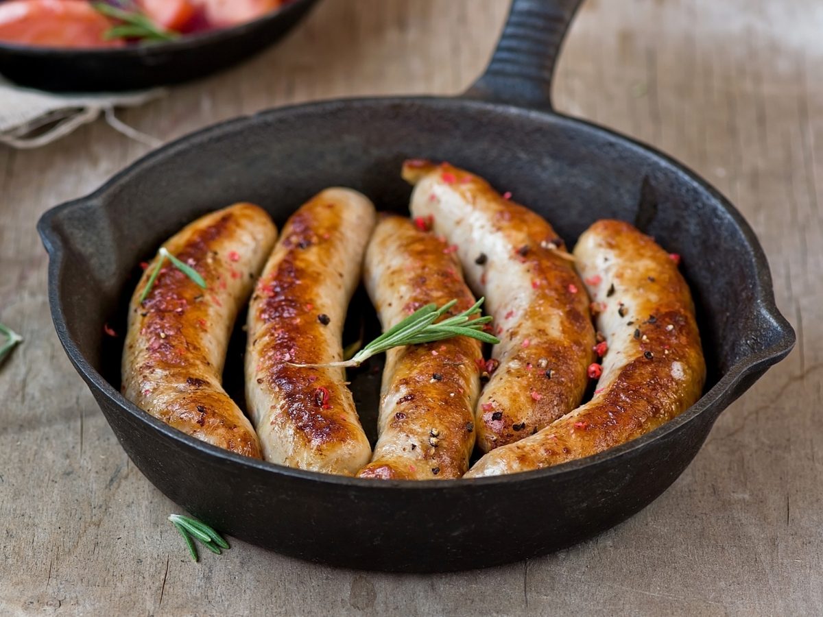 Breakfast sausages in a cast-iron pan