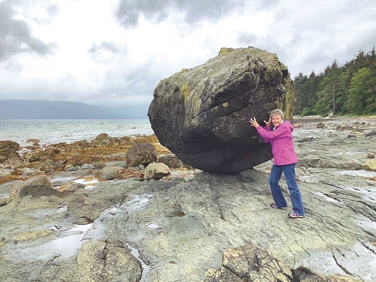 Penny "holding up" the Balance Rock in Skidegate