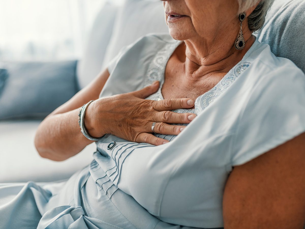 Woman with hand to chest