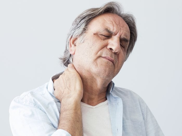 heart attack symptoms - Senior man holding neck