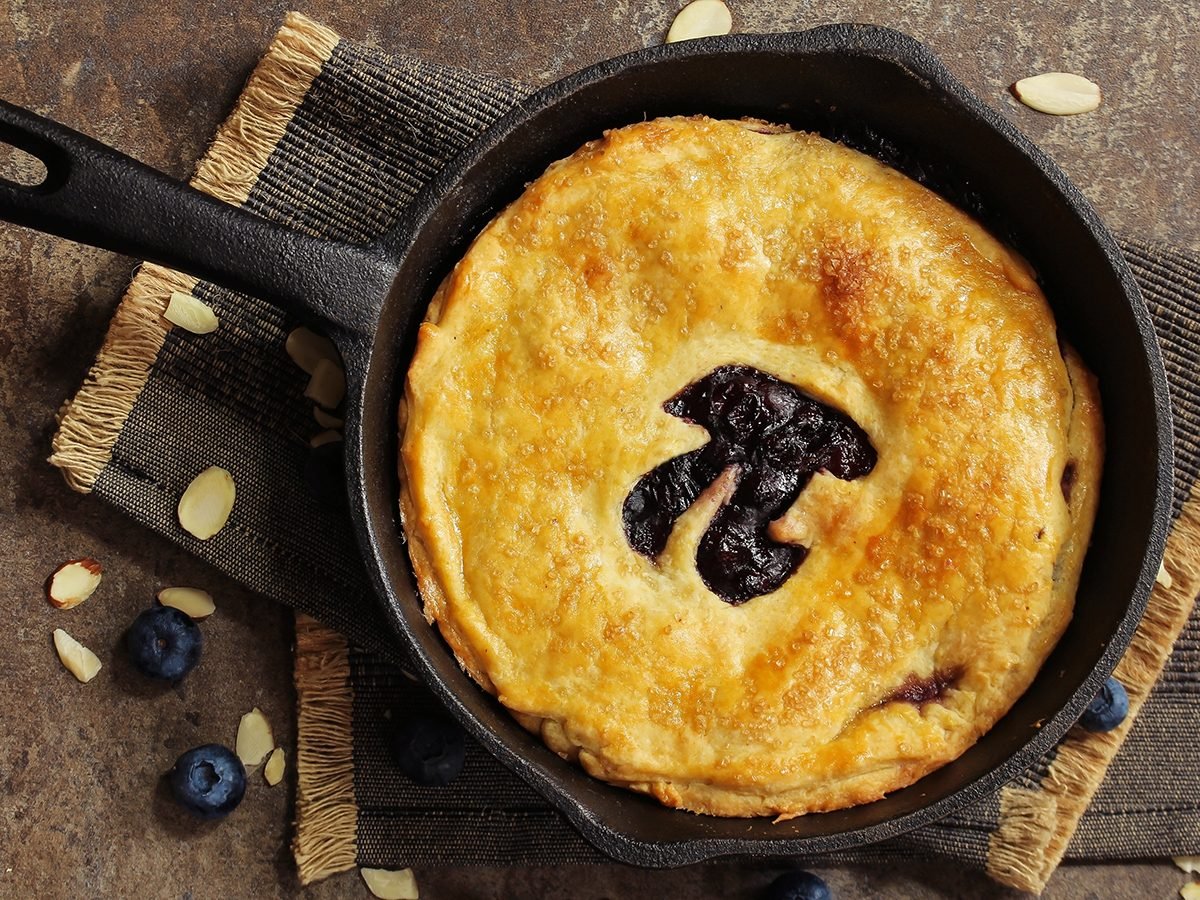 Pi Day special homemade blueberry pie baked in a skillet overhead view