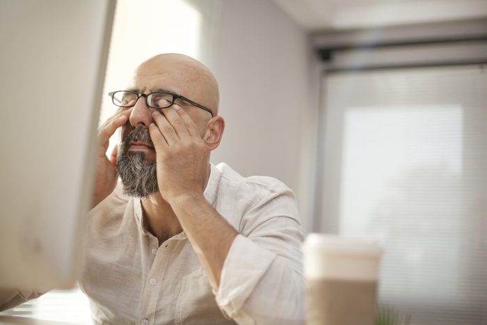 Signs you need new glasses - Senior businessman rubbing his tired eyes