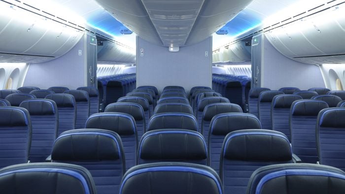 787 dreamliner commercial airplane cabin interior with blue leather seats