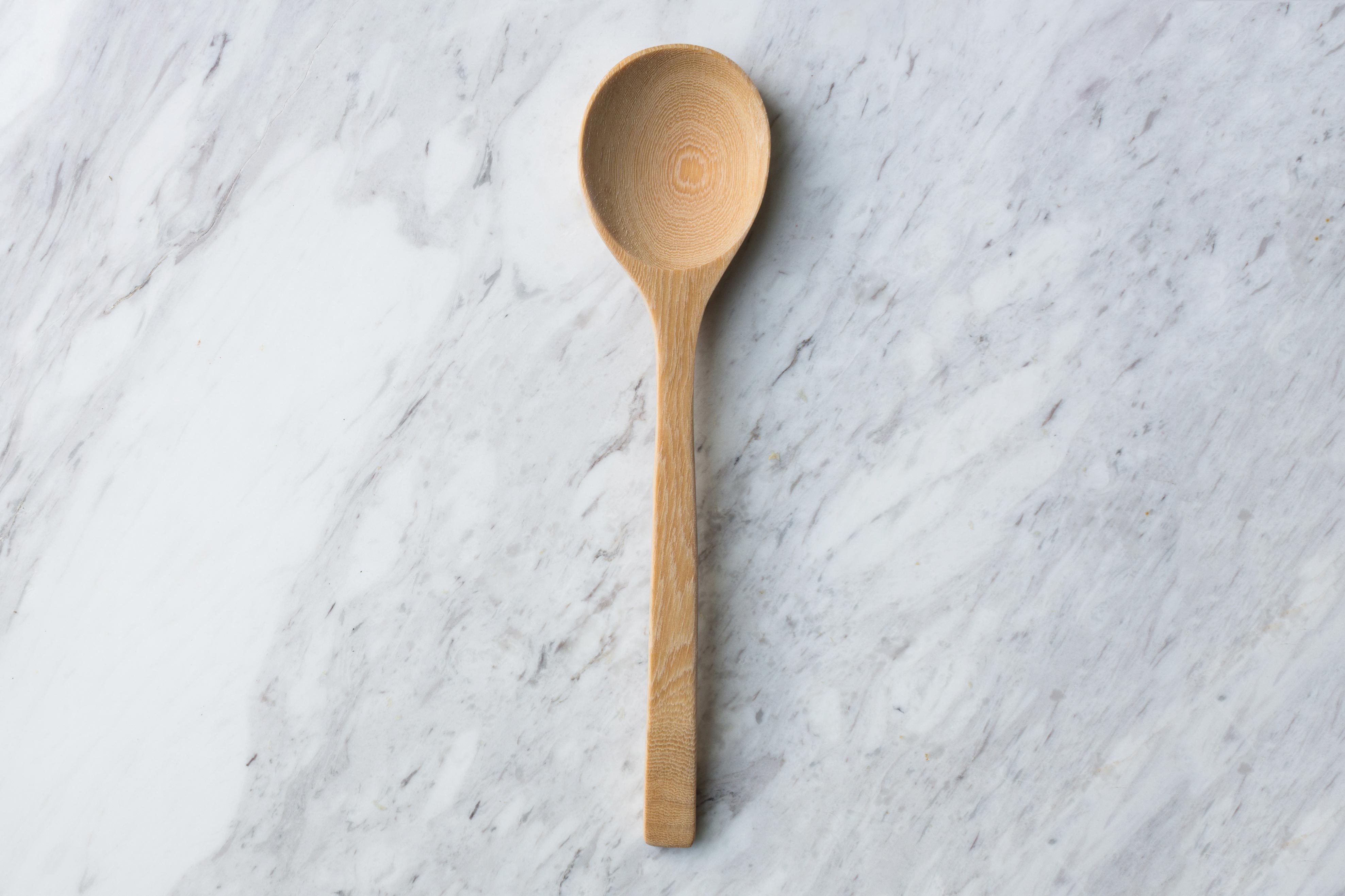 wooden spoon on marble countertop background