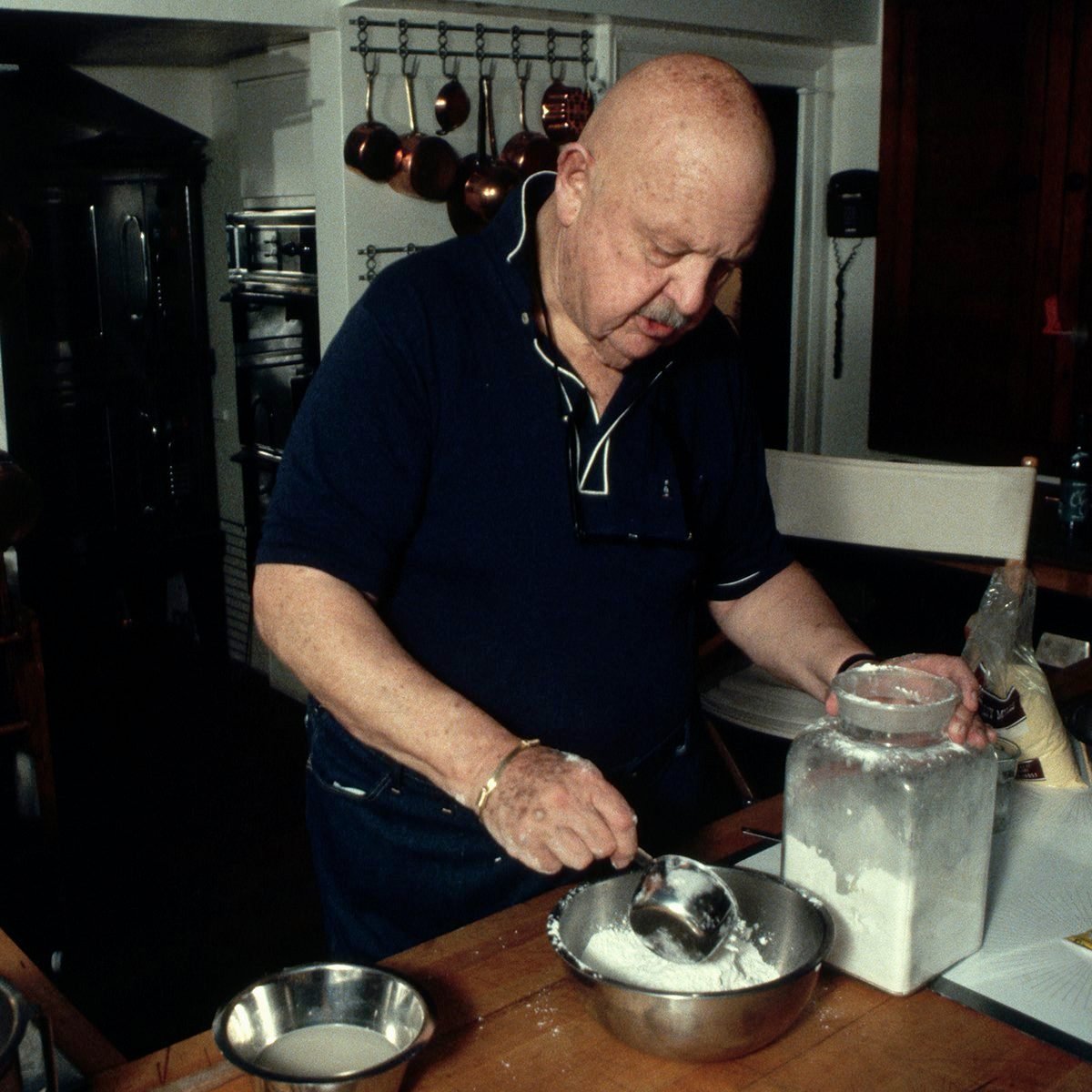 James Beard, a famous food critic, prepares a meal in his kitchen at home. (Photo by �� Jacques M. Chenet/CORBIS/Corbis via Getty Images)