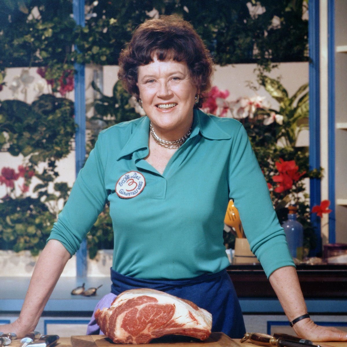 A portrait of the American chef Julia Child (1912 - 2004) shows her standing with a cut of meat in her kitchen, late 20th century. (Photo by Bachrach/Getty Images)