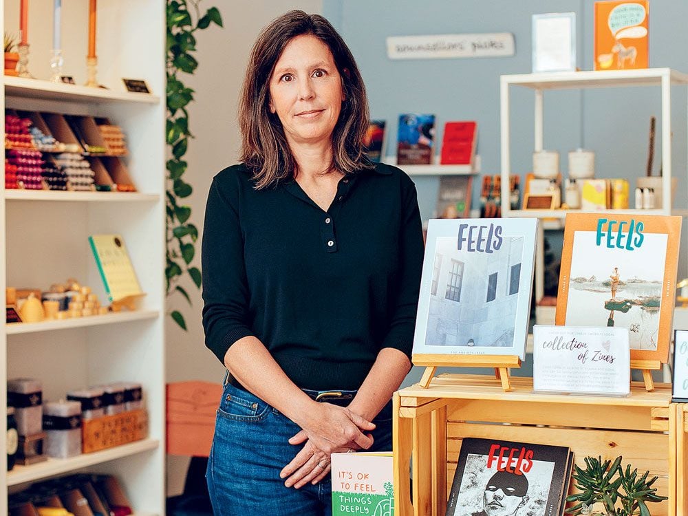 Hard Feelings founder Kate Scowen stands in front of a bookshelf at her mental health clinic.