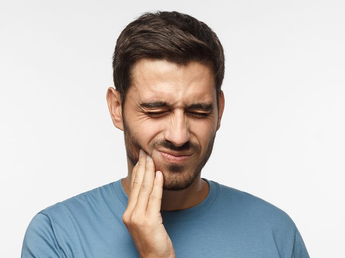 Cancer symptoms - man with sore mouth