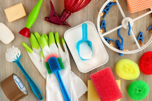 Household utensils for hygiene and cleanliness. Washing powder, clothespins, rubber gloves, brushes are household items. View from above. House utensils of different kinds. Hygiene products for home.