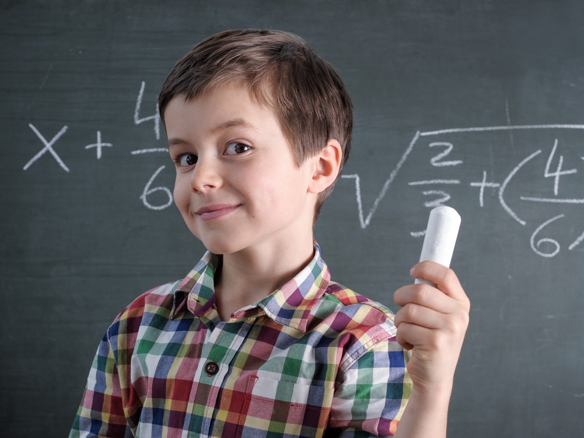 Young boy solving math equations