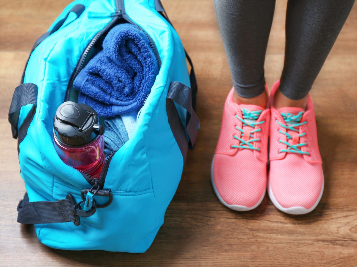 Close-up of gym bag and woman's trainers