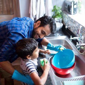 Healthy home checklist - Father and son cleaning dishes in the kitchen